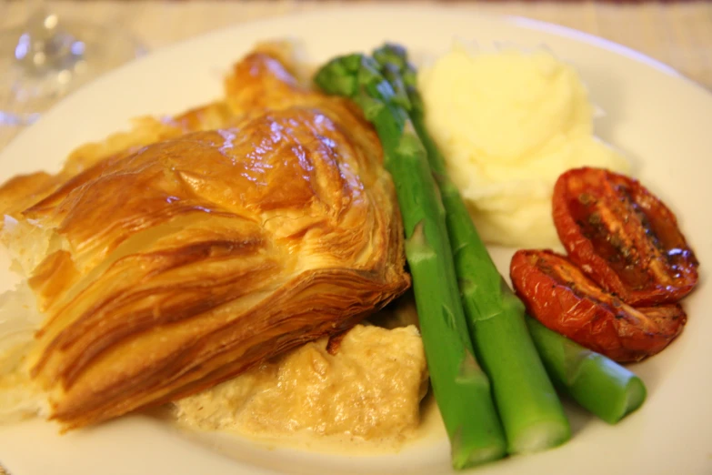 a plate with green beans and potatoes and a pastry