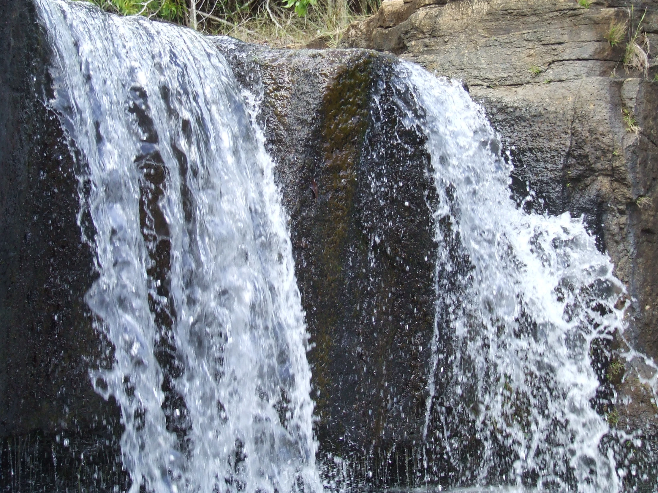 some very big pretty waterfall and rocks by the water