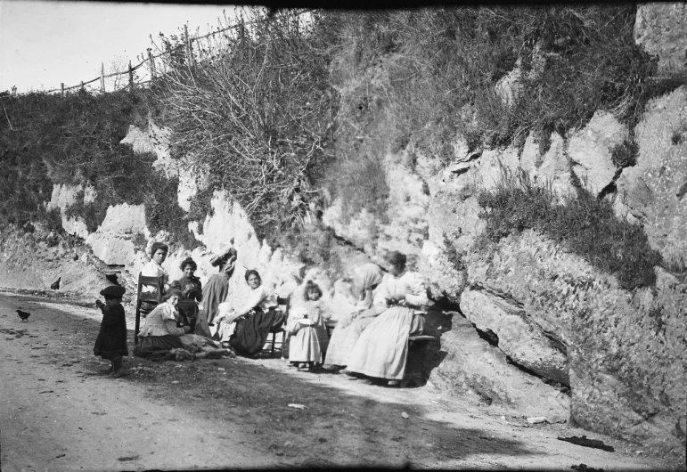 antique pograph of women on roadside with children