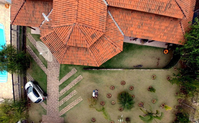 overhead view of houses with several cars parked in the driveway