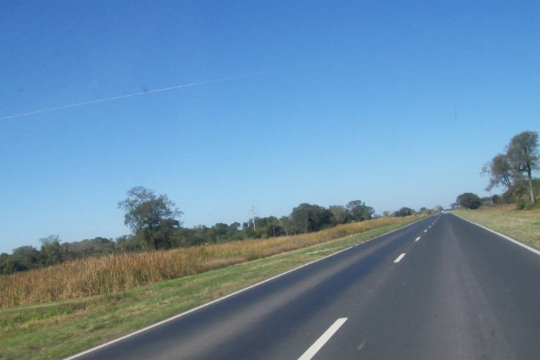 a long road with a single car sign in the middle