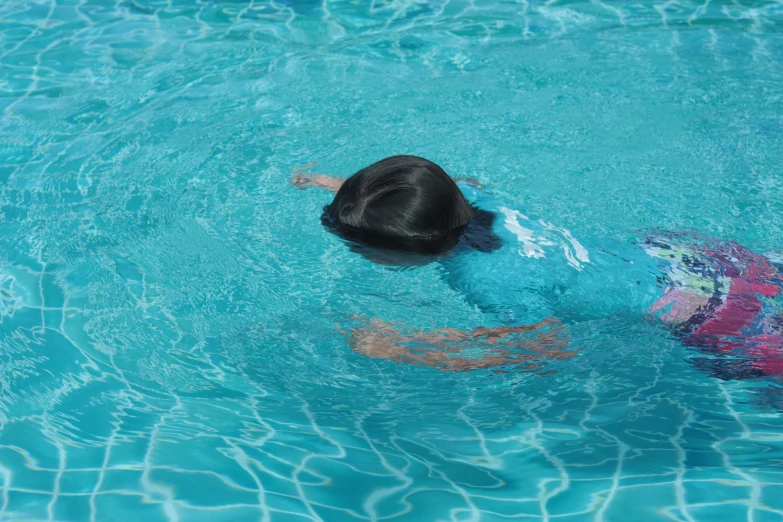 a person swimming in a pool with water around them