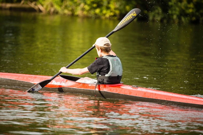 a man is paddling a boat in the water