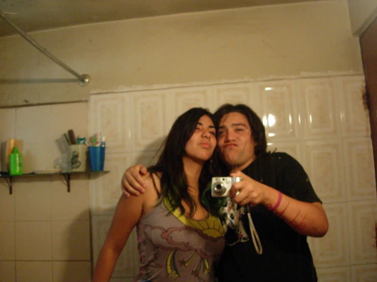 a couple taking a selfie while in the bathroom