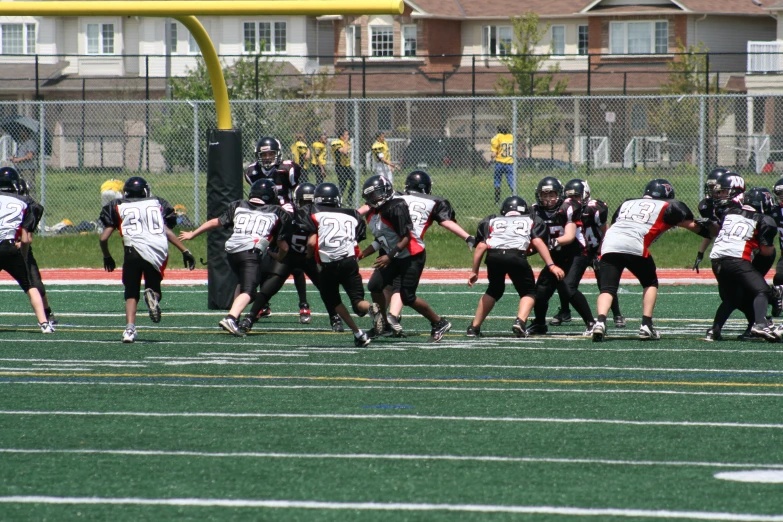 a bunch of boys are in the middle of playing football