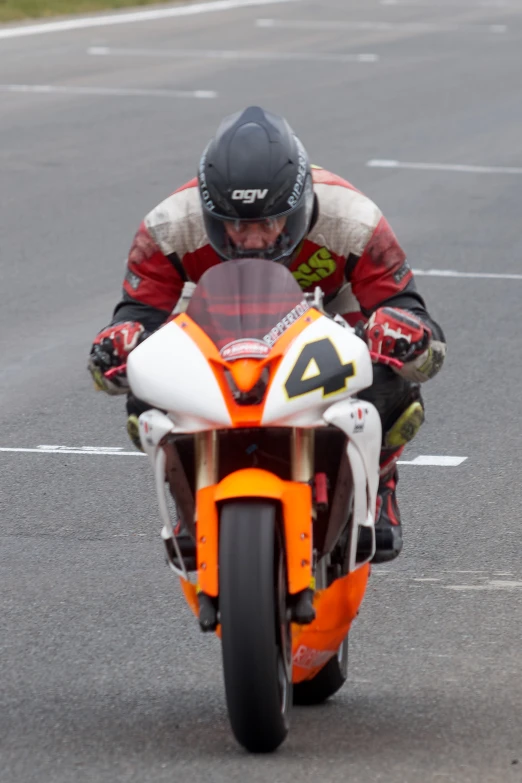 a person on a motorcycle riding down the road