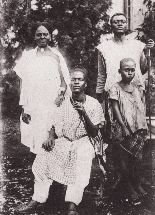 several people sitting on grass posing for a picture