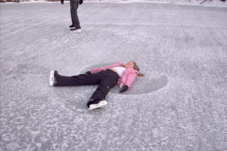 the woman is lying in the snow near two others