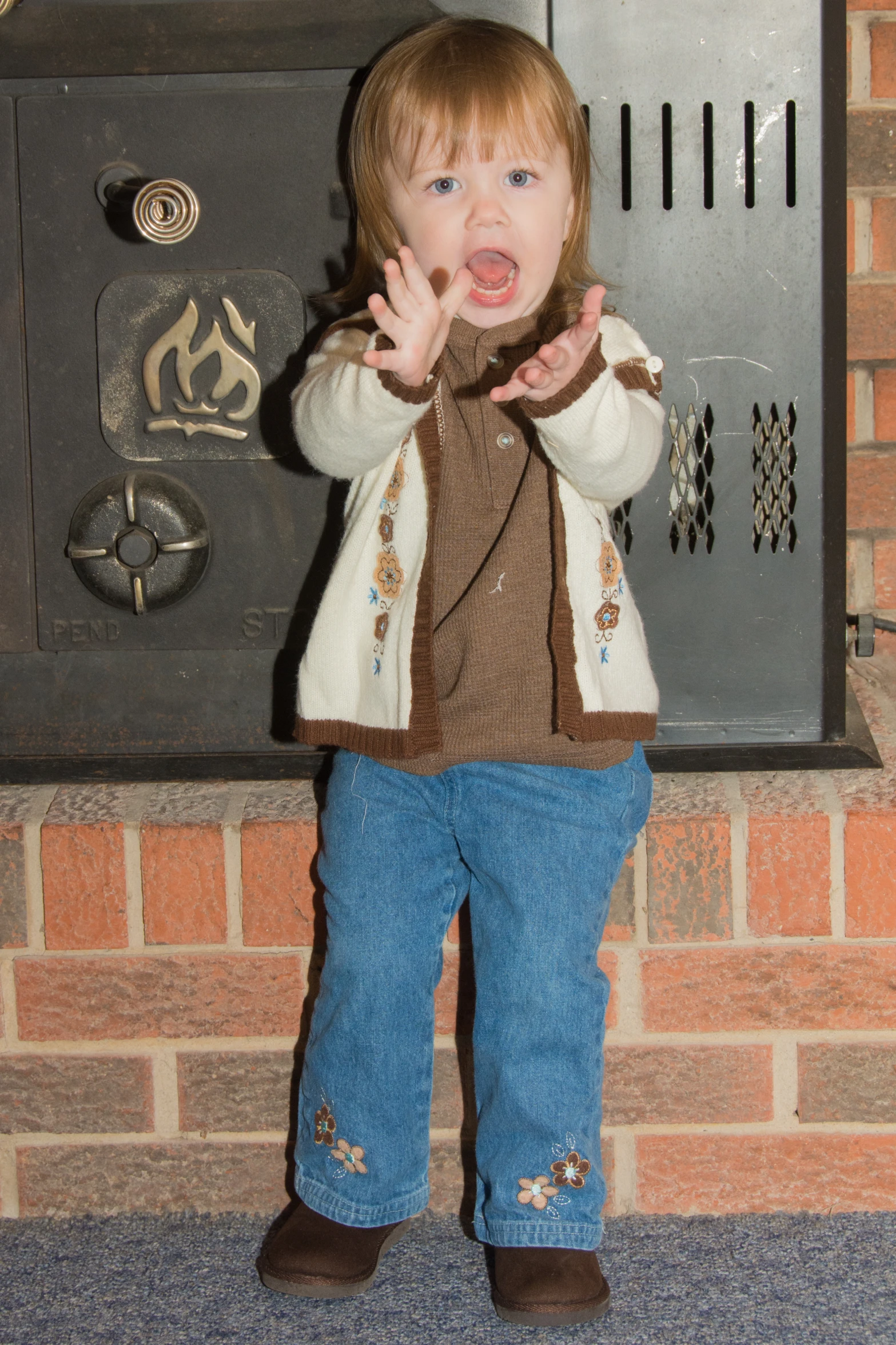 a young child standing near a metal mailbox