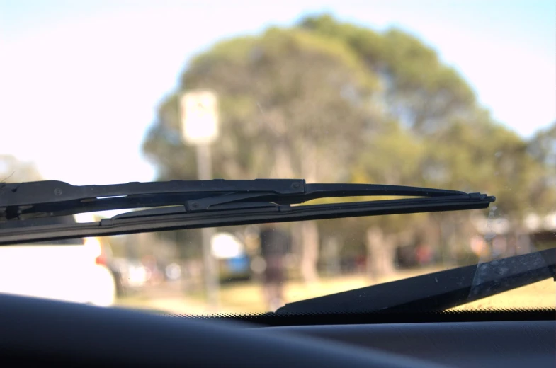 a pair of scissors on the windscreen of a car