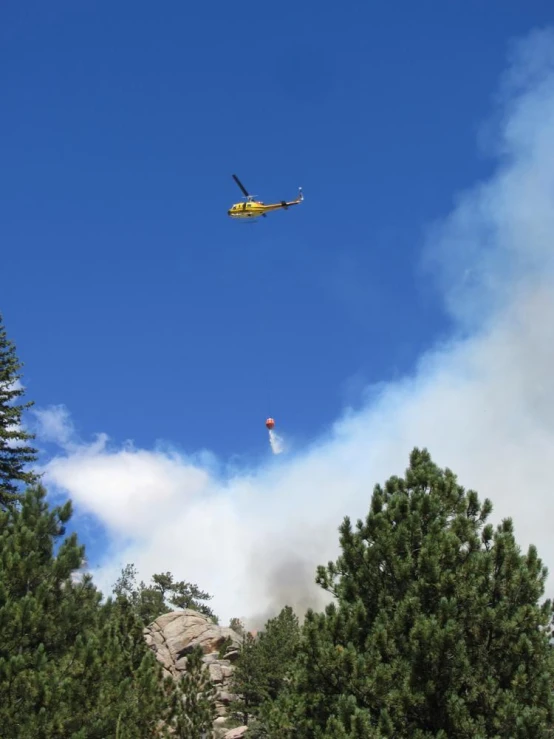 a helicopter is flying low on the blue sky