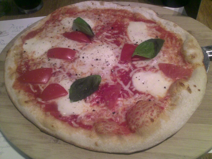 a close up of a small pizza on a table