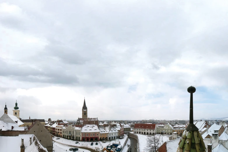 a town on a snowy day with buildings in the background