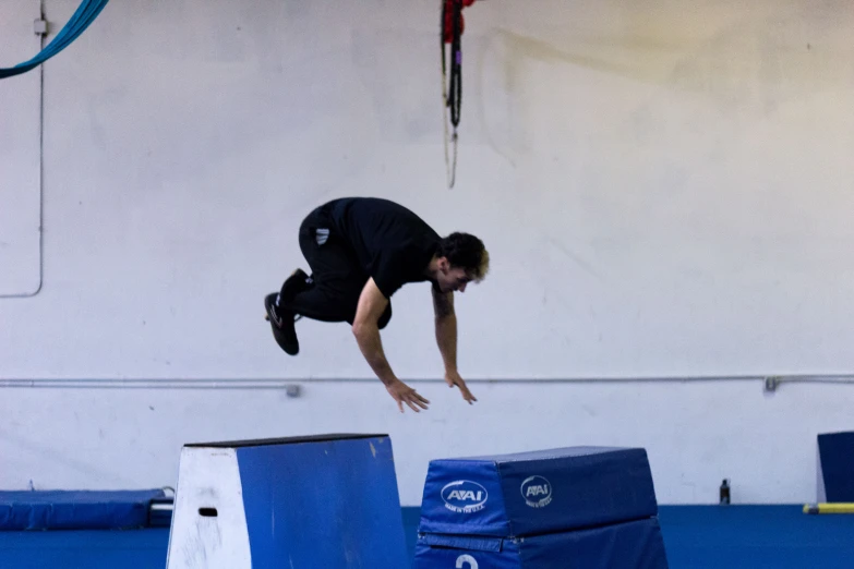 a man is doing tricks on a trampoline