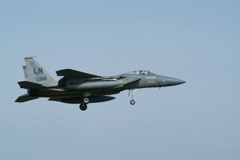 an army plane flies in the sky and is ready to take off