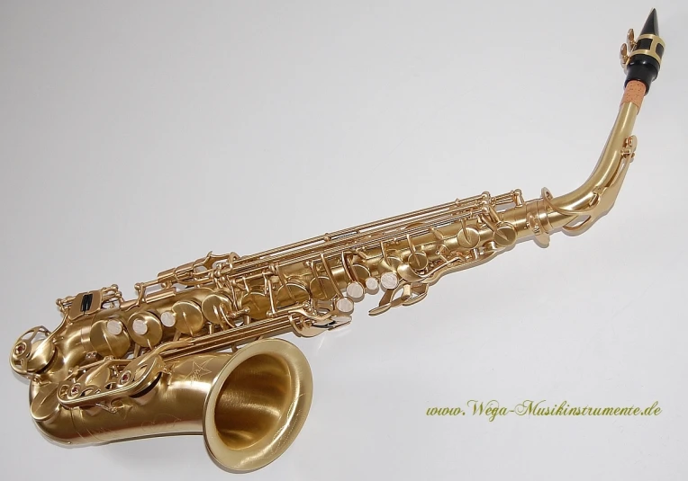 an alto saxophone sitting on a white background