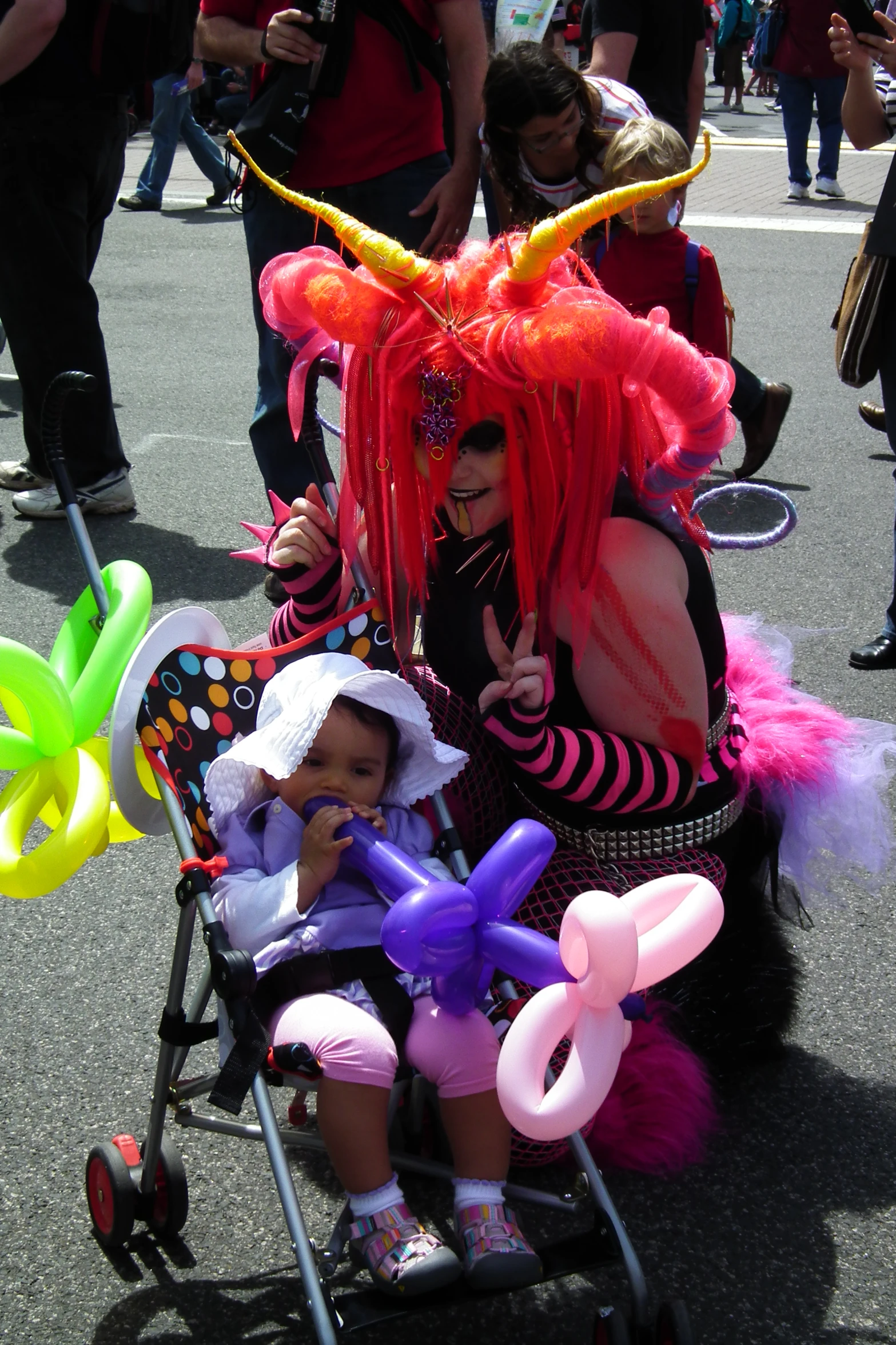 woman in costume is hing her baby in a stroller