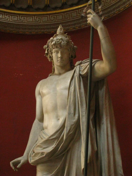 a statue with a staff in his hand