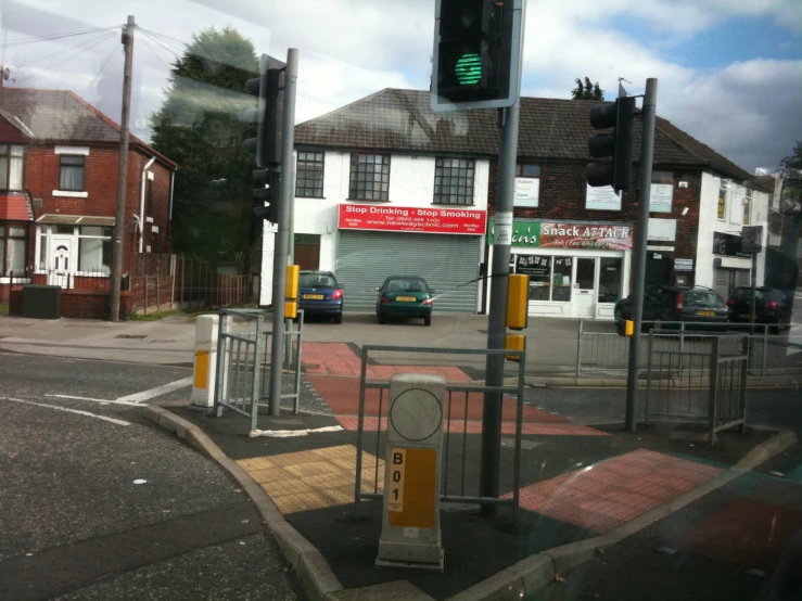 a street intersection with a traffic signal and a store front