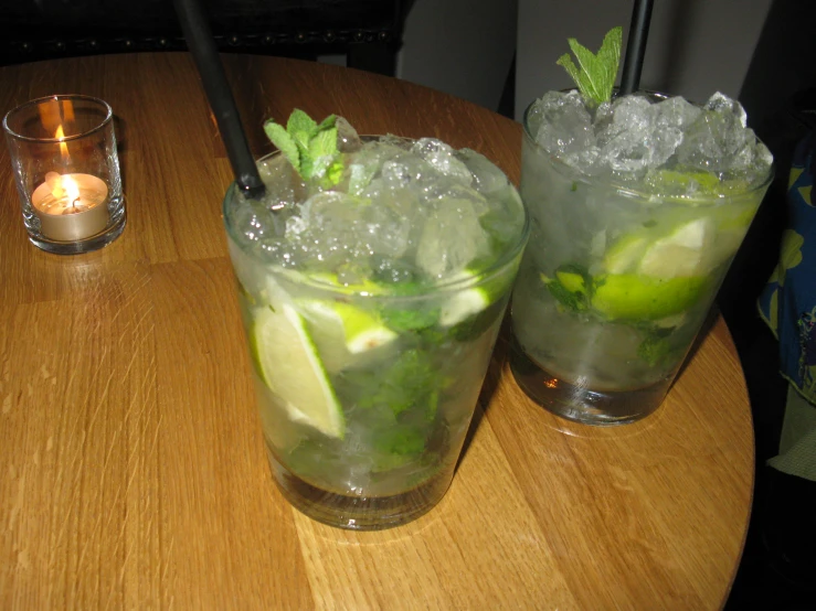 two glasses of ice tea with limes on the table