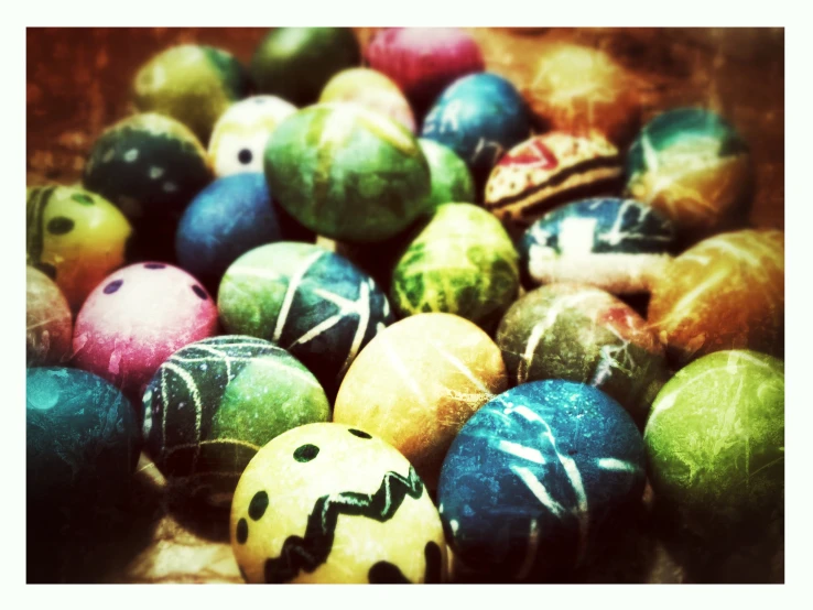 a large pile of colorful easter eggs on the ground