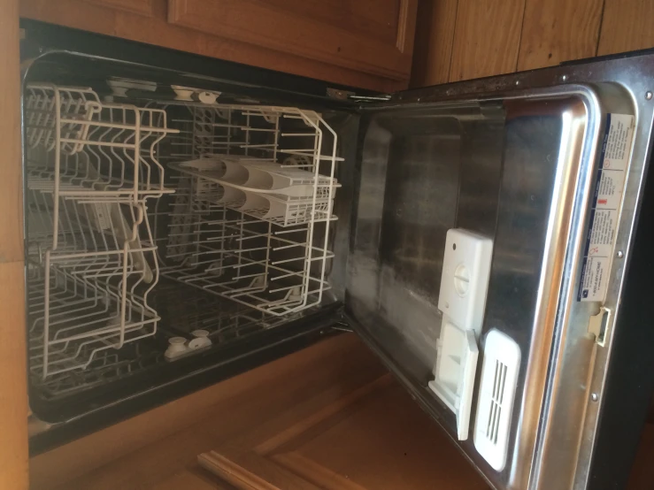 an empty dishwasher is sitting on the floor