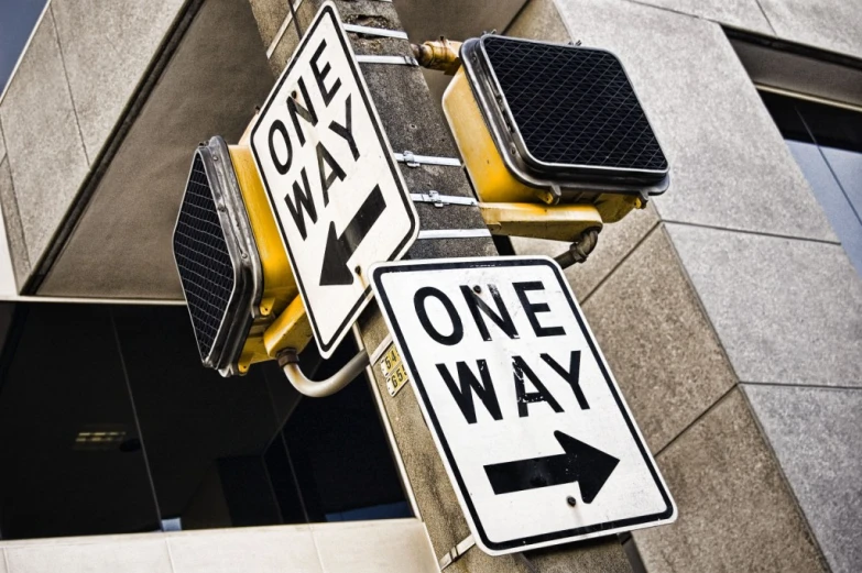 street sign on post with one way and one way signs