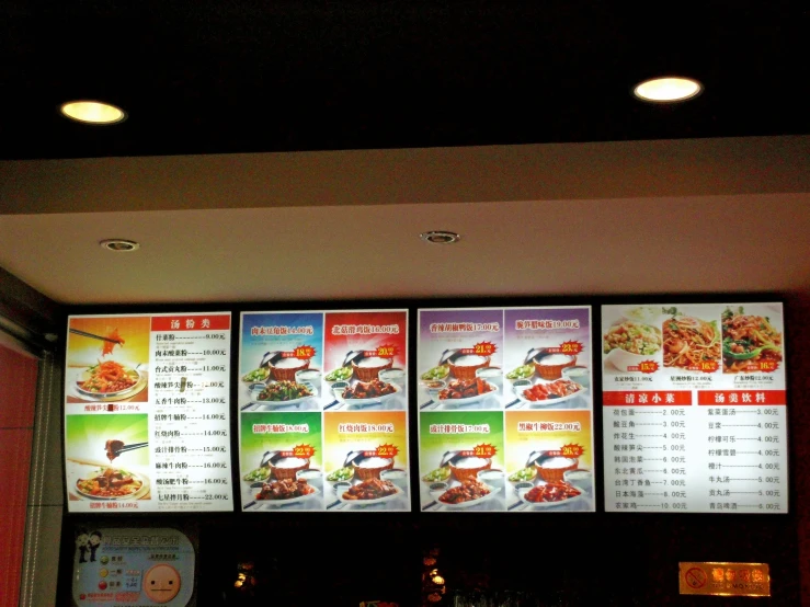 large menu board in a restaurant above the counter