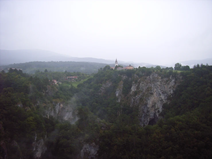 a foggy mountain with a church on top