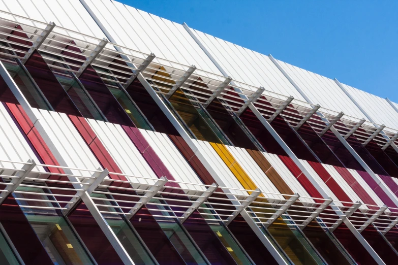 a multi - colored striped building is shown against the blue sky