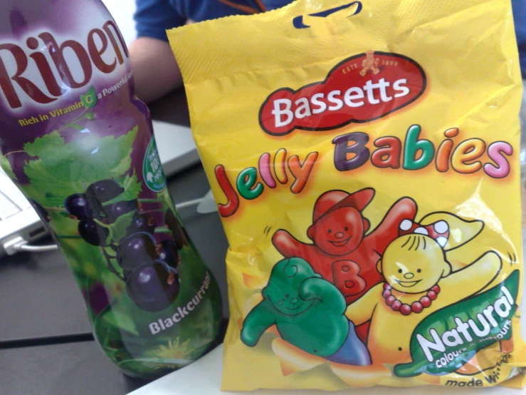 a bag and a bag of fruit in front of a bottle