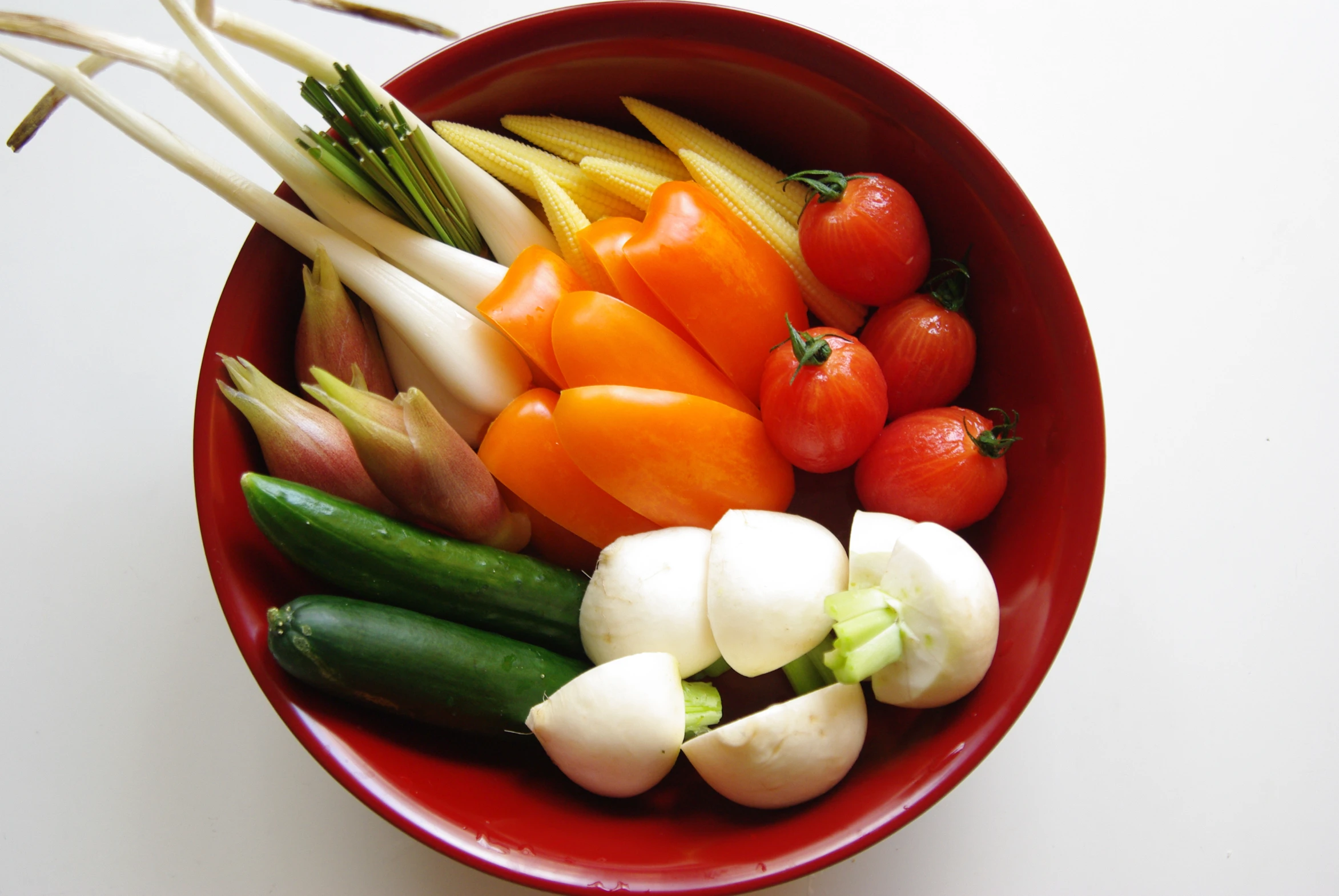 small assortment of colorful vegetables in a red bowl