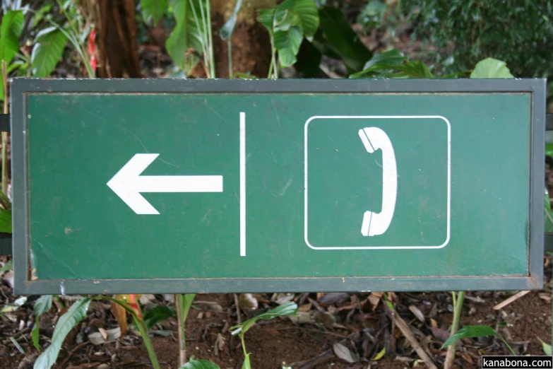 a green sign with a call center and an arrow pointing to the left