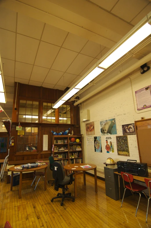 the classroom has tables and desks along with books