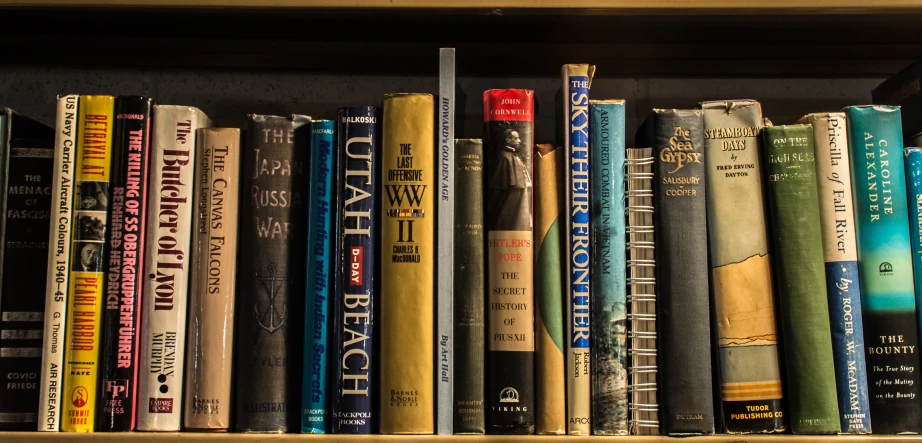 a bookshelf with several different kinds of books on it