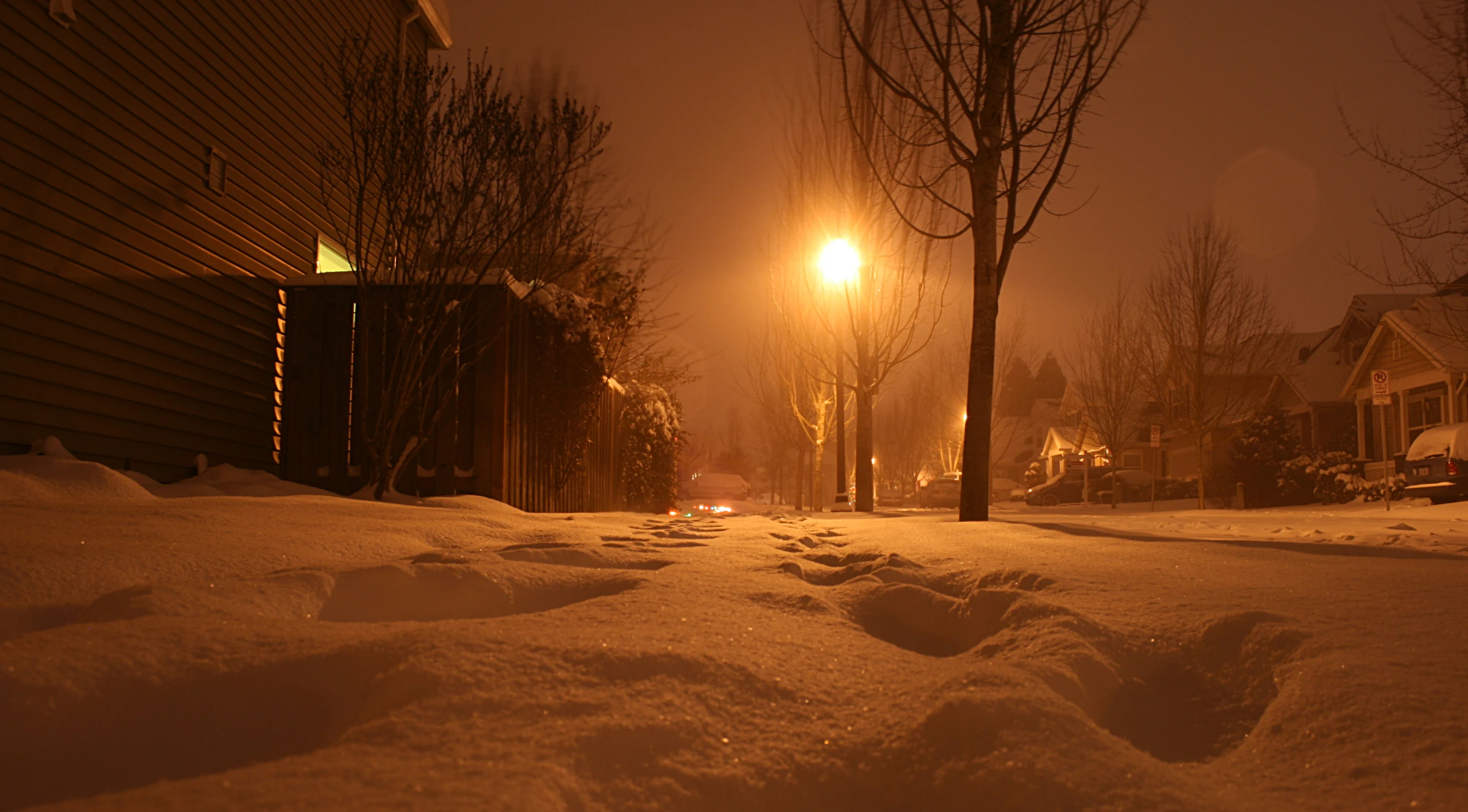 a person riding their bike down the street in the snow