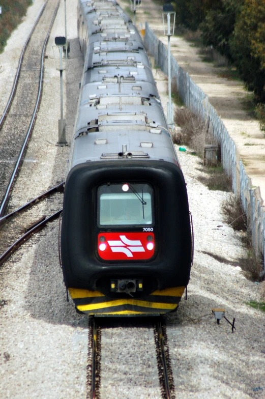 the view looking down at a train that is on tracks