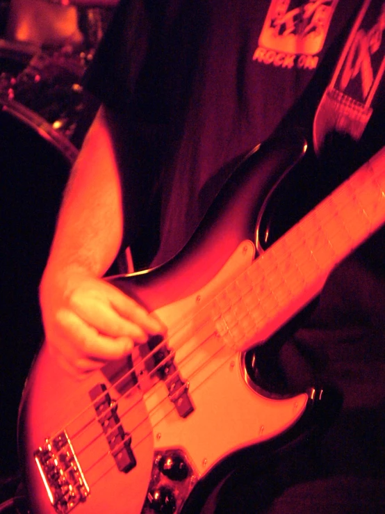 a person playing an electric guitar while sitting down