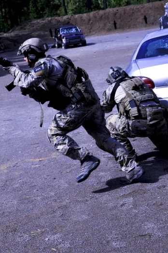 soldiers with weapons running toward a vehicle