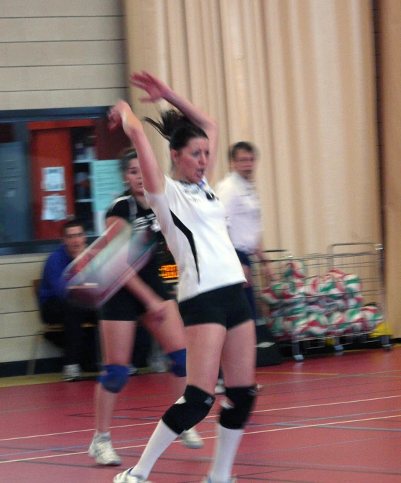 two women who are playing some sport in the gym