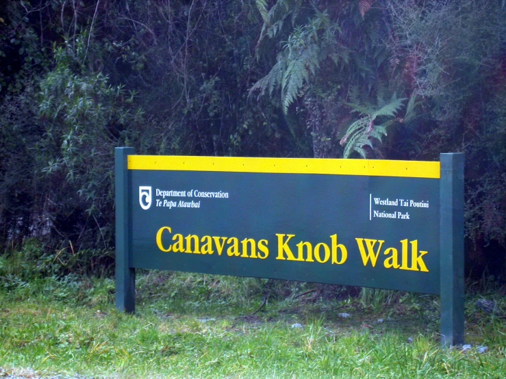 a sign is displayed in front of some trees