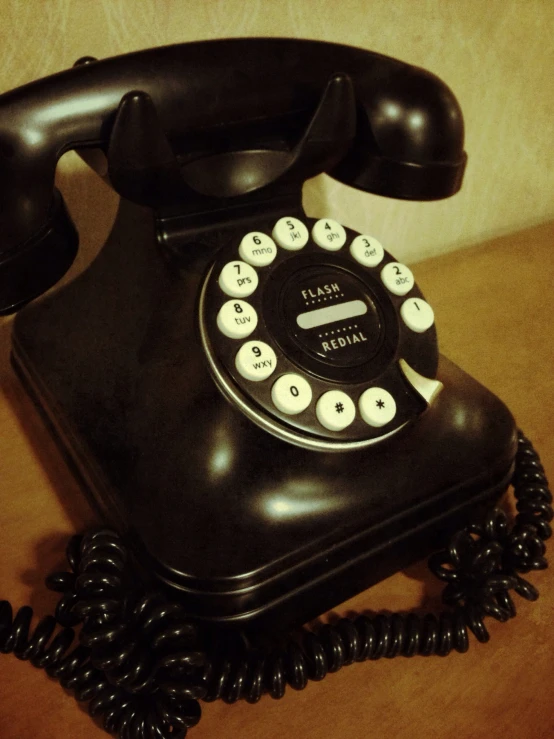 an old - fashioned phone sits open with its hands