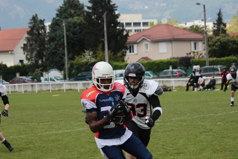 football players running through the field with each other