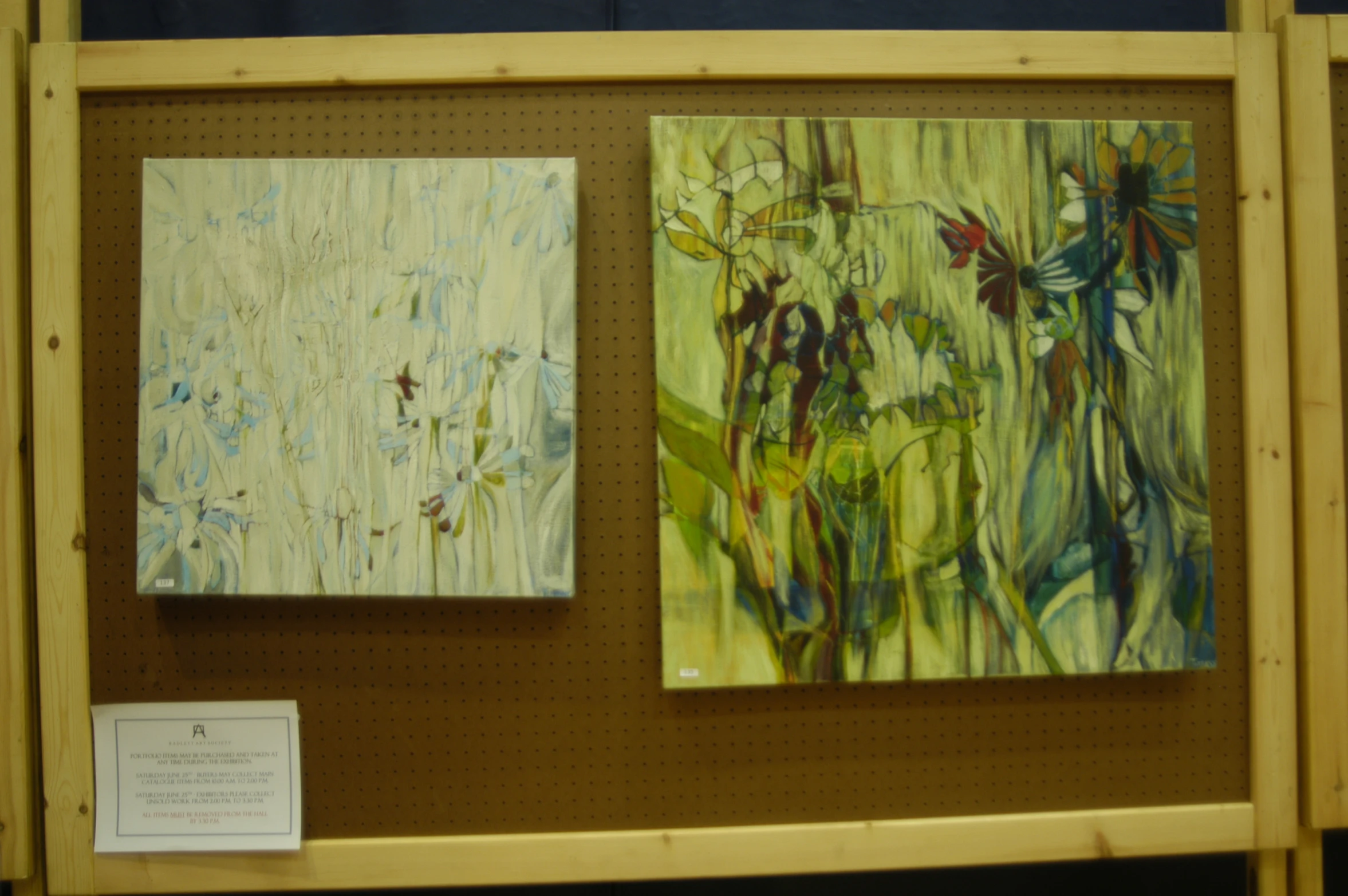 paintings are on display in a wooden frame