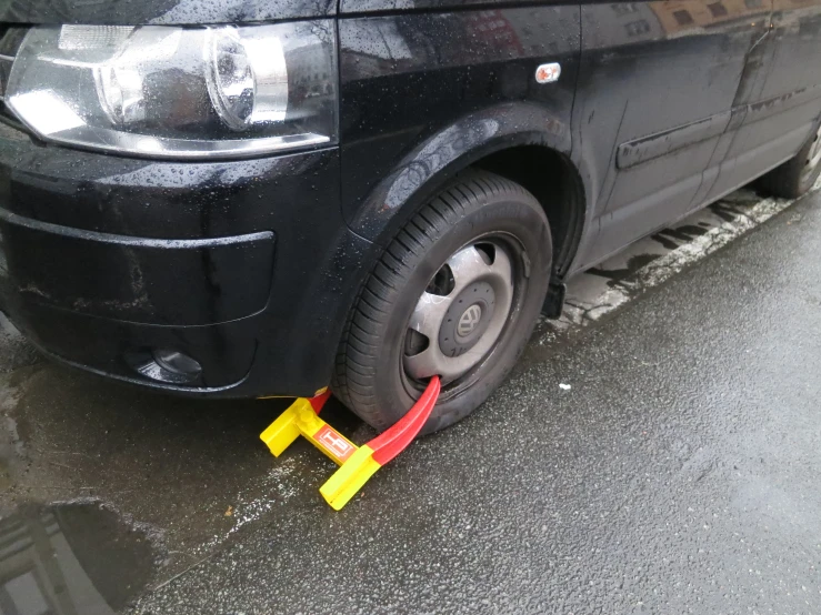 the front end of a car with some red and yellow signs around it