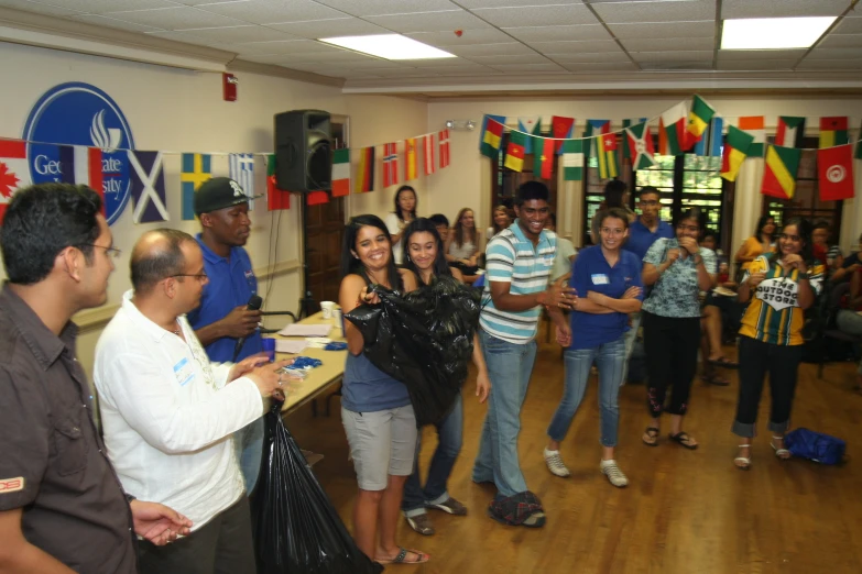 people are standing around in a room with flags