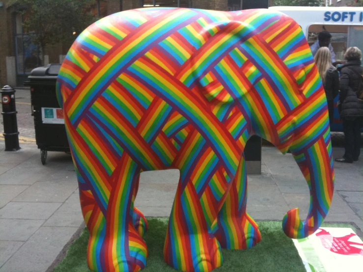 a statue of an elephant is painted in rainbow colors