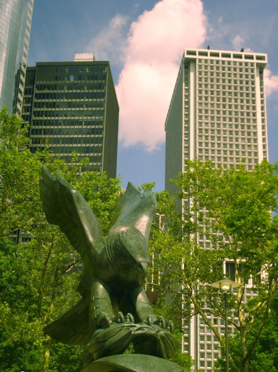 a tall building with two large buildings in the background