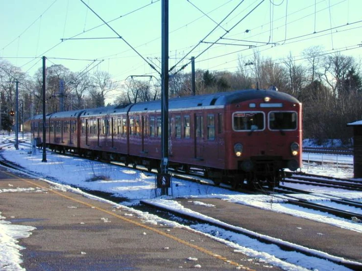 a train passing through the snow covered station