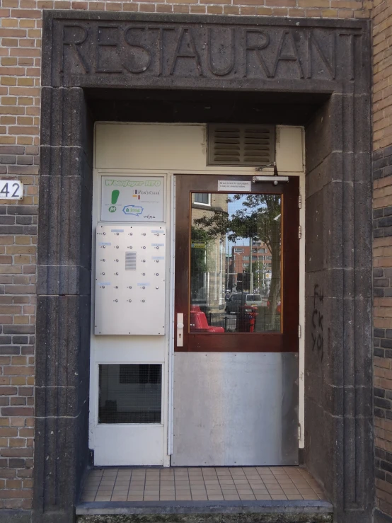 an open door to a building with a small screen for entering